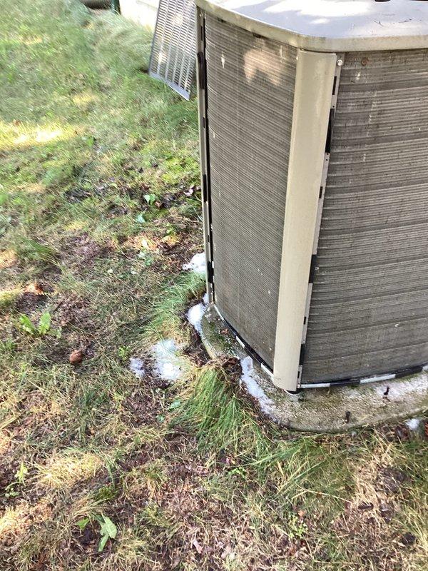 Responded to service call for central air conditioning system with reduced cooling capacity and extended run times. Upon inspection, accessed outdoor condensing unit and evaluated compressor, refrigerant lines, and electrical connections. System was still operational but performing below optimal efficiency. Documented unit condition with photos showing outdoor condenser placement and internal components including compressor housing, refrigerant lines, and electrical wiring for service records and future reference.