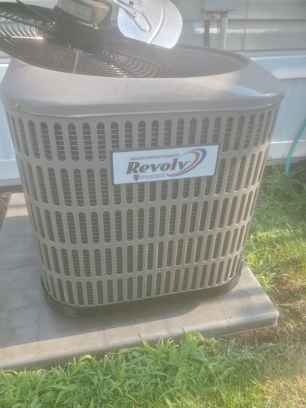 Completed scheduled cooling system tune-up maintenance on Revolv outdoor condenser unit. System was operating properly upon arrival; performed comprehensive inspection of mechanical components, motor assembly, and fan operation. Verified proper airflow through ventilation slots, confirmed unit stability on concrete pad, and documented equipment condition with no issues found.