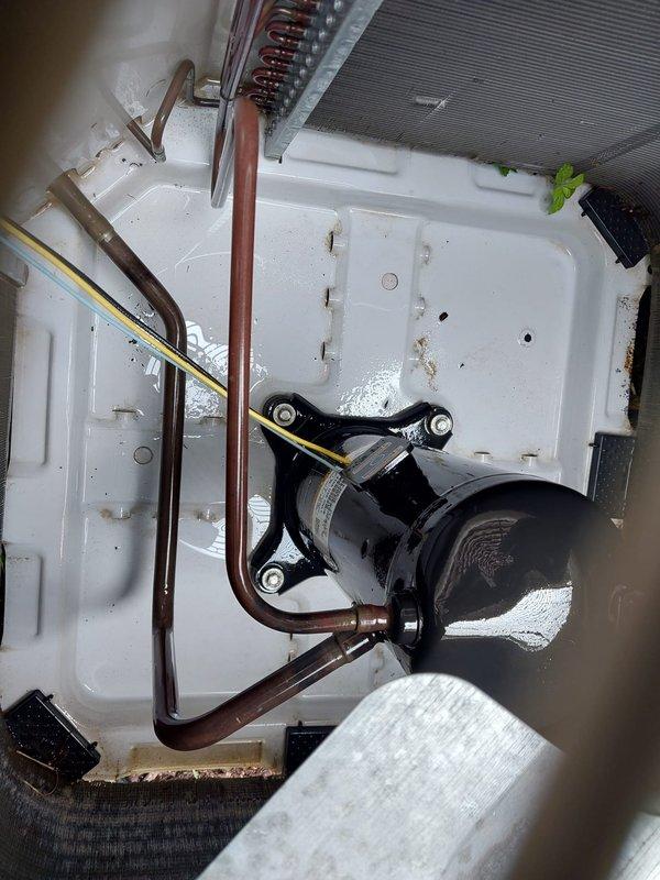 Completed annual air conditioner tune-up on Payne brand outdoor condensing unit located on west side of residence. Performed comprehensive maintenance inspection including visual assessment of condenser coil condition, fan motor operation, refrigerant line integrity, and electrical connections. Inspected evaporator coil assembly and condensate drain system, noting normal moisture presence in drain pan with minor debris accumulation. All components found operating within normal parameters with no immediate service needs identified. Unit showing typical wear consistent with outdoor installation but maintaining proper function.