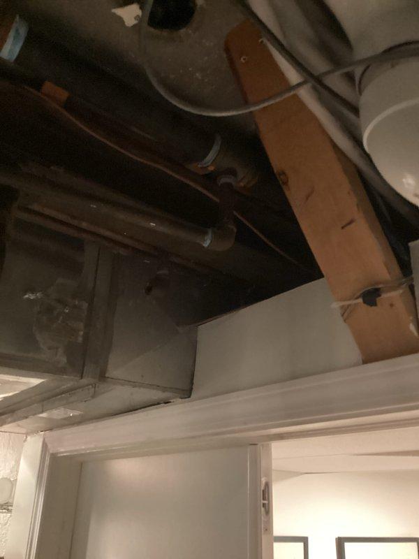 Completed electrical estimate for installation of a 2-4 person residential generator system at property currently without backup power. Assessed existing electrical panel configuration, documented circuit breaker layout and available capacity, and evaluated basement utility area for optimal generator placement and electrical integration. Photographed current electrical infrastructure including main distribution panel with labeled circuits and unfinished ceiling space showing existing copper plumbing, PVC piping, and electrical wiring runs to determine routing requirements for new generator transfer switch and connection conduits.