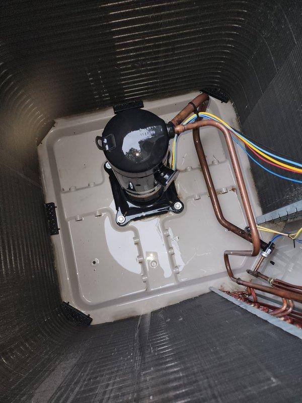 Completed scheduled cooling system tune-up and maintenance on properly functioning HVAC unit. Inspected and photographed condenser coil fins showing partial dirt accumulation on lower section, compressor unit with refrigerant lines and electrical connections, and verified all components operating within normal parameters. System confirmed working properly with no repairs required.