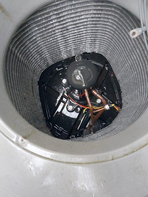 Performed comprehensive air conditioning maintenance on residential cooling system as part of DTE Energy rebate program. Conducted thorough inspection of outdoor condensing unit, verifying proper operation of compressor assembly and refrigerant line connections. Examined condenser coil fins for cleanliness and airflow efficiency—coils found in good condition with uniform appearance throughout. Inspected copper refrigerant lines and fittings for signs of leaks or damage; all connections secure with no visible defects. Verified adequate clearance around outdoor unit and checked ventilation grille for proper airflow. Documented system condition with photographs for rebate program compliance. Unit operating within normal parameters upon completion of maintenance procedures.