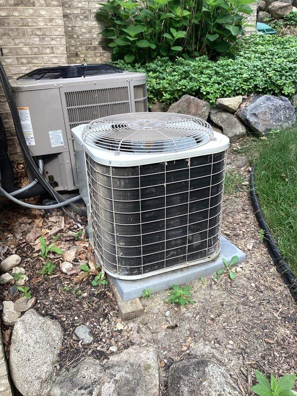 Completed comprehensive HVAC system replacement estimate for second of two residential units, with first system already successfully replaced. Site assessment documented existing cylindrical air conditioner condenser and rectangular heat pump unit positioned on concrete pad against exterior brick wall, connected via refrigerant lines and electrical conduit to wall-mounted disconnect box. Provided detailed replacement specifications and equipment recommendations to match previously installed system for consistent performance across property.