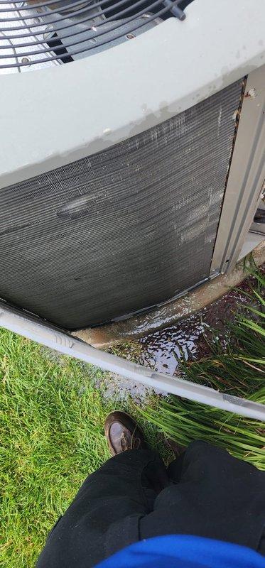 Completed routine AC maintenance on residential split system. Inspected outdoor condenser unit, noting dirty coil fins and water accumulation at base on concrete pad. Accessed indoor air handler to examine blower assembly, refrigerant lines, and drain pan. Verified all mechanical components, mounting hardware, and copper line insulation intact with normal operational wear. System operational at time of service.