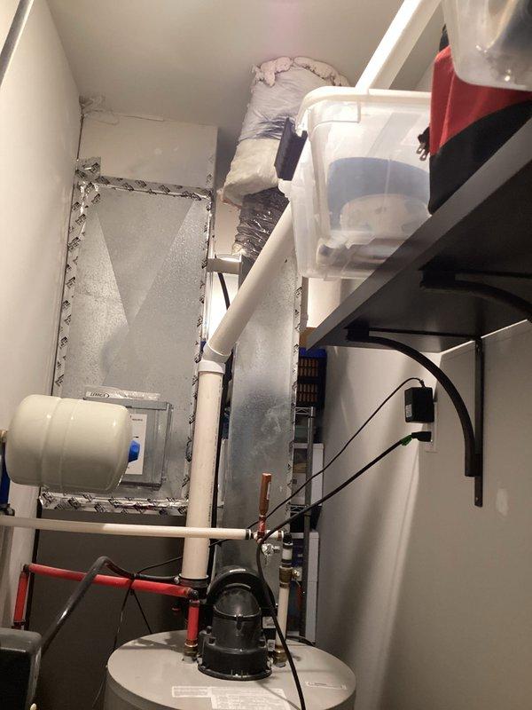 Completed comprehensive estimate for water heater replacement in residential mechanical room. Evaluated existing Bradford White Defender water heater installation, documented current equipment configuration including copper supply piping with red-handled isolation valves, black flex connector at flue assembly, and proper venting arrangement. Assessed mechanical room layout and clearances for replacement unit installation, noting confined space with adjacent HVAC air handler, PVC drainage system, and humidifier equipment. Provided homeowner with detailed replacement options and specifications for new water heater installation.