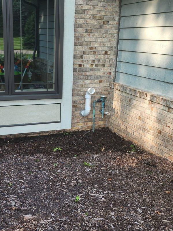 Completed installation of 50-gallon tanked water heater in basement utility area, replacing existing unit. Connected all copper supply lines, installed proper venting through exterior wall with white PVC piping and blue valve assembly, and secured unit per code requirements with appropriate mounting hardware on concrete foundation.