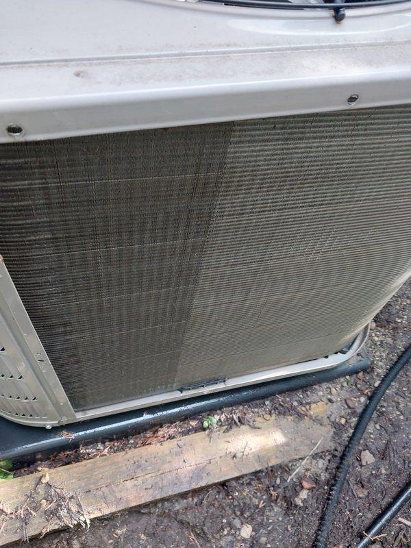 Responded to no cooling complaint on residential air conditioning system. Upon arrival, found outdoor condenser coil heavily soiled with dirt, debris, and environmental contaminants restricting airflow. Performed thorough coil cleaning to restore proper heat transfer efficiency. Inspected indoor evaporator coil and drain pan, found standing water in condensate pan indicating potential drainage issue. Verified system operation after cleaning, confirmed adequate airflow restoration and proper cooling function. Unit returned to normal operating condition.