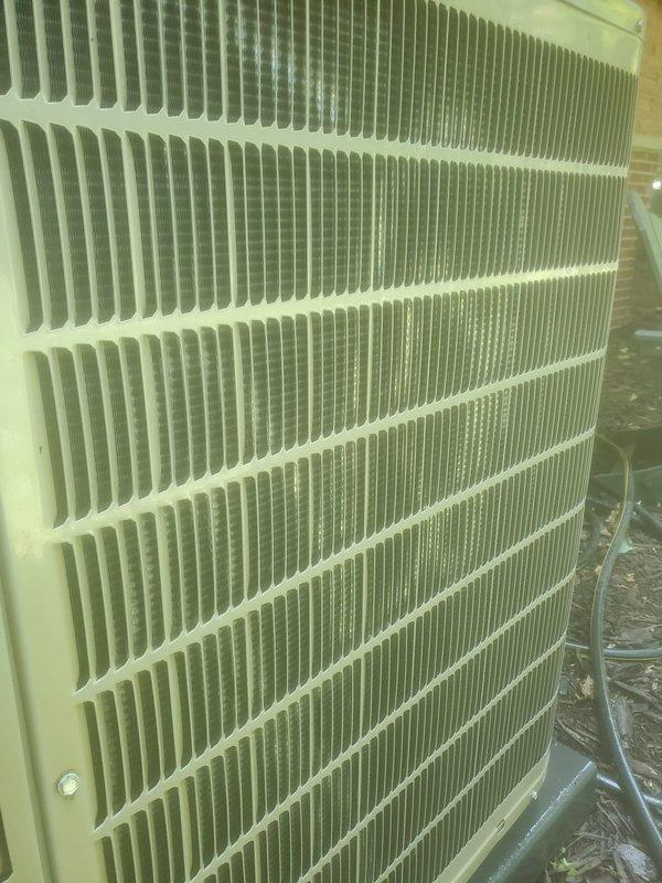 Completed scheduled cooling system maintenance and tune-up on properly functioning HVAC system. Inspected indoor compressor unit, refrigerant lines, and condensate drain pan; noted normal moisture accumulation and age-related staining in pan. Evaluated outdoor condenser unit with protective grille, verified fin condition with typical outdoor exposure and dust accumulation, and confirmed all components operating within normal parameters.