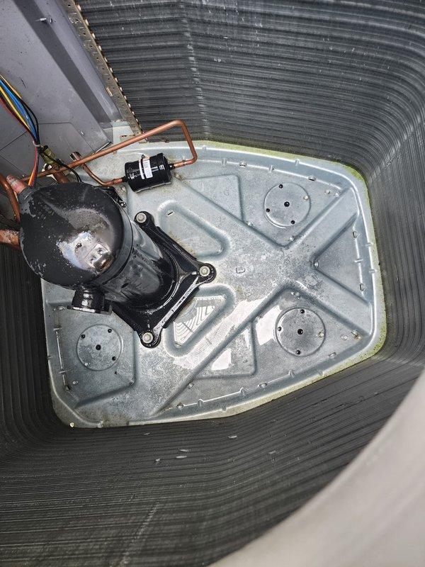 Completed preventive maintenance on residential air conditioning system. Inspected outdoor condenser unit, noting accumulated debris on protective grille which was cleaned to ensure proper airflow. Verified fan motor operation and internal components functioning normally. Inspected indoor air handler assembly, checking condensate pump, drain lines, and electrical connections for proper operation and secure mounting.