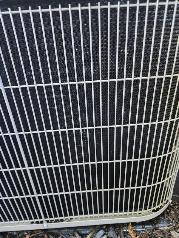 Completed preventive maintenance on residential cooling system during scheduled service window. Performed comprehensive inspection of outdoor condensing unit, including visual assessment of condenser coil fins, protective grille condition, and compressor assembly with associated refrigerant lines and electrical connections. Unit found in operational condition with normal component wear patterns observed.