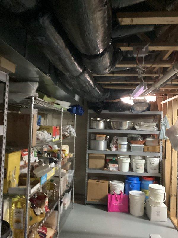 Conducted comprehensive evaluation of aging 20-year-old air conditioning system located in basement mechanical room. Assessed current air handler unit with Lennox equipment, documented existing HVAC infrastructure including ductwork distribution system, and photographed equipment condition to provide accurate replacement recommendations. System currently operational but nearing end of service life, requiring full replacement estimate for modern, energy-efficient cooling solution.