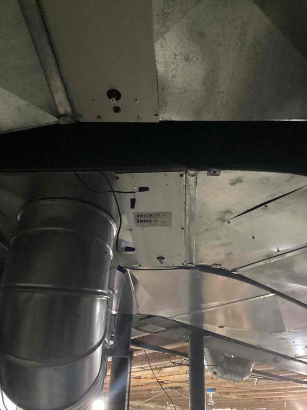 Conducted comprehensive assessment of existing water heater installation in basement mechanical room for replacement estimate. Evaluated current unit configuration including gas supply line, circulation pump with electrical components, copper piping connections, and venting system. Documented existing setup showing water heater positioned between water softener and secondary storage tank, with digital controller mounted on wall for system management. Inspected overhead venting and ductwork routing through ceiling structure. Assessed accessibility for replacement work and photographed all mechanical connections, gas line placement, electrical wiring, and surrounding equipment to provide accurate replacement estimate. No active service issues reported with current unit.