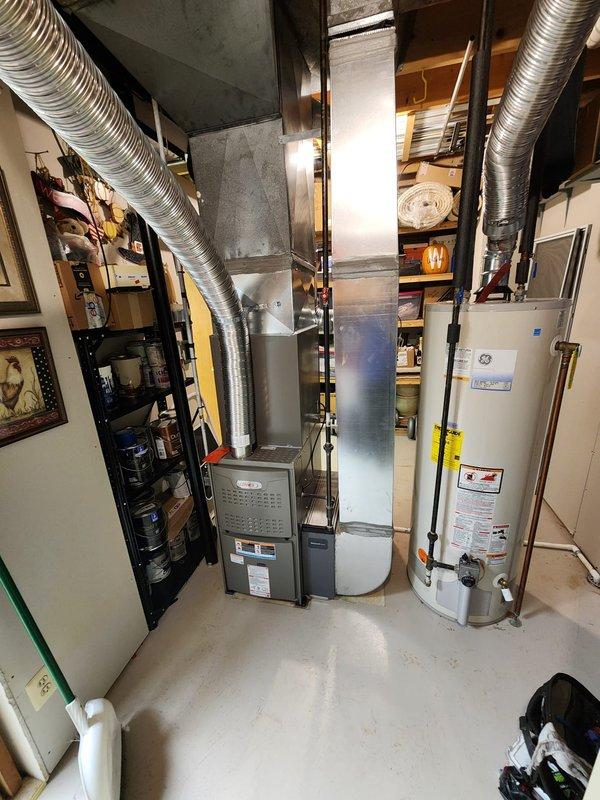 Completed full HVAC system installation including Lennox furnace, air conditioning unit, and humidifier in basement utility area. Mounted humidifier on return plenum as specified, installed all necessary ductwork connections, and verified proper venting configuration. All equipment tested and operational upon completion, with system ready for service.