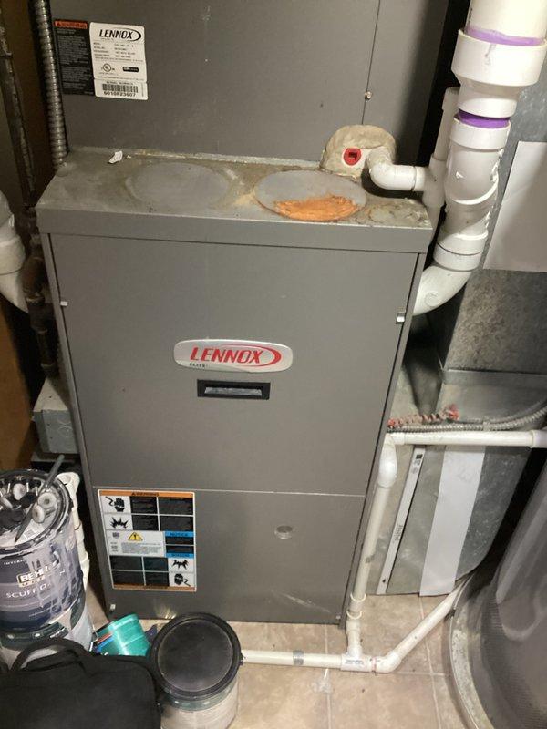 Provided comprehensive estimate for complete HVAC system replacement including air conditioning unit, furnace, and tankless water heater to replace 16-year-old equipment. Existing air conditioning unit is non-operational while furnace remains functional; assessed current Lennox system installation in basement utility area with natural gas fuel source. Documented existing equipment configuration, PVC condensate drainage, ductwork connections, and clearance requirements to prepare detailed replacement proposal for full system upgrade.