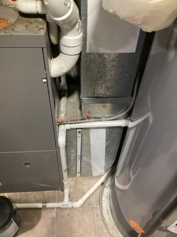 Provided comprehensive estimate for complete HVAC system replacement including air conditioning unit, furnace, and tankless water heater to replace 16-year-old equipment. Existing air conditioning unit is non-operational while furnace remains functional; assessed current Lennox system installation in basement utility area with natural gas fuel source. Documented existing equipment configuration, PVC condensate drainage, ductwork connections, and clearance requirements to prepare detailed replacement proposal for full system upgrade.