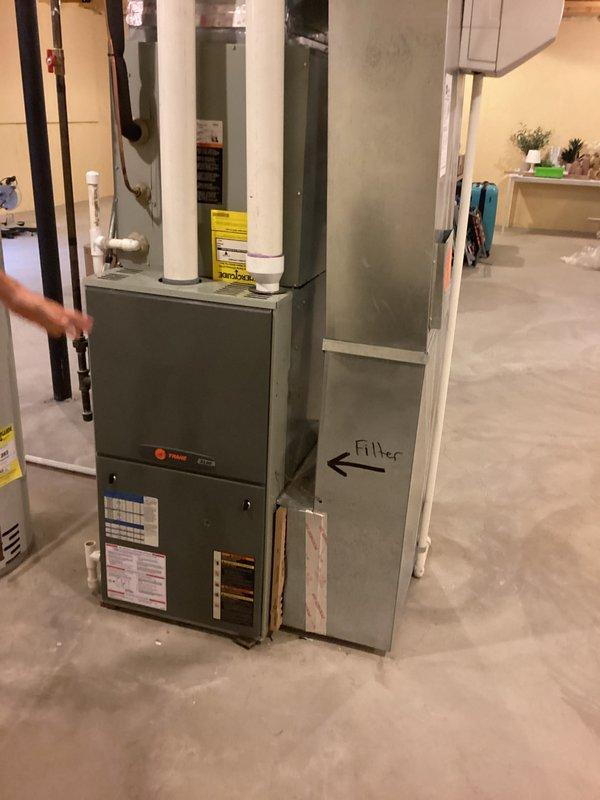 Conducted comprehensive estimate for complete HVAC system replacement at residential property. Evaluated existing 19-year-old Trane furnace and 9-year-old air conditioning system located in unfinished basement utility area. Documented current equipment specifications, assessed ductwork configuration, and photographed existing installation including condensate drainage lines, PVC venting, and sheet metal distribution system. Provided homeowner with replacement options and recommendations based on equipment age and condition.