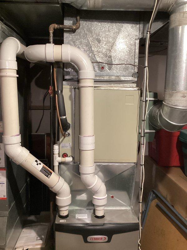 Provided comprehensive estimate for complete HVAC system replacement of 36-year-old non-operational air conditioning unit and aging Lennox furnace located in basement utility room. Assessed existing equipment configuration including ductwork, PVC condensate drainage system, copper refrigerant lines, and electrical connections to determine specifications for new system installation. Documented current setup with existing drain pan, humidifier component, and spatial constraints for replacement equipment sizing and placement recommendations.