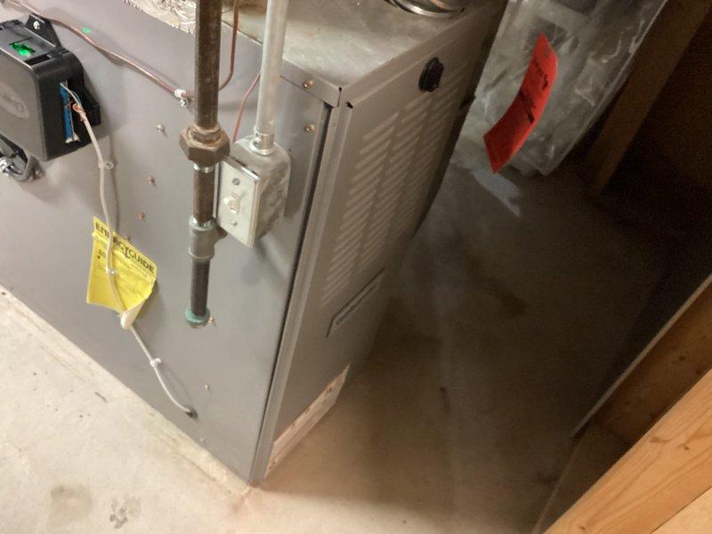 Completed installation of Lennox air conditioning system in basement utility area, including proper integration with existing furnace unit. Connected refrigerant lines, electrical controls with indicator lights, and PVC condensate drainage system, with all ductwork properly insulated and secured. Retrieved customer's portable air conditioning unit and returned it to shop as requested.