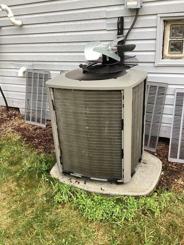 Responded to service call for air conditioning system not operating properly. Upon arrival, performed visual inspection of outdoor condensing unit and found heavily soiled filter/insulation material visible through open service panel, along with accumulated dirt and debris on unit components. Cleaned condenser coils, replaced dirty filter media, and verified proper airflow through louvered panels. Tested fan motor assembly operation and confirmed electrical connections at disconnect box were secure. System restored to normal cooling operation with improved airflow efficiency.