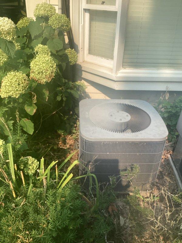 Completed estimate for replacement of two residential air conditioning systems currently operating on R-22 refrigerant. Both outdoor condenser units were inspected and found to be low on refrigerant charge. Documented existing equipment configuration including exterior-mounted condensers and attic-installed air handlers requiring ladder access and 1/4 inch nut driver for service panel entry. Photographed current system conditions and provided replacement recommendations due to refrigerant charge loss and obsolete R-22 refrigerant type.