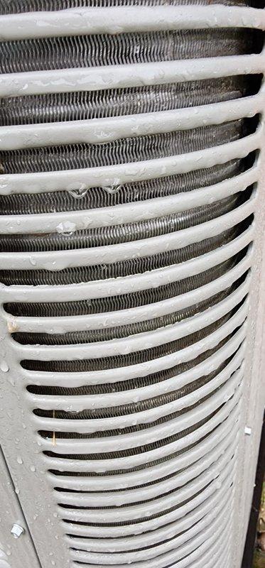 Completed scheduled cooling system maintenance and tune-up on residential HVAC unit. During inspection, identified significant frost and ice buildup on condenser coil fins, indicating potential airflow restriction or refrigerant issue. Performed comprehensive system evaluation, checked refrigerant levels, cleaned condenser coils, inspected copper line connections and mounting hardware for leaks or damage, verified proper drainage, and confirmed system returned to normal operating condition with no further icing present.