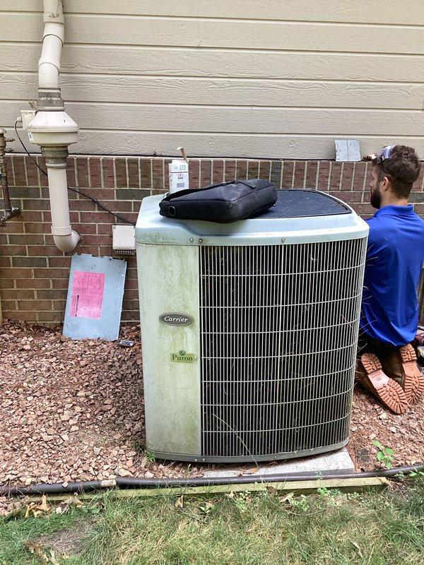Performed comprehensive assessment of 20-year-old Carrier Puron air conditioning system showing significant age-related deterioration, including exterior weathering, algae growth, and discoloration on cabinet panels. Evaluated unit's internal components, electrical connections, and mechanical systems to determine feasibility of repair versus replacement. Recommended full system replacement due to advanced age, declining efficiency, and cost-effectiveness analysis indicating replacement as the more economical long-term solution compared to major repair investment on aging equipment.