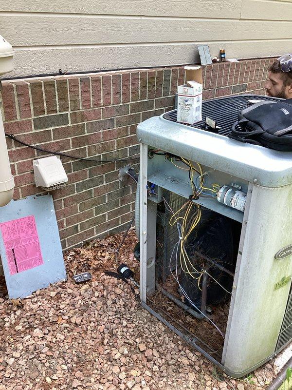 Performed comprehensive assessment of 20-year-old Carrier Puron air conditioning system showing significant age-related deterioration, including exterior weathering, algae growth, and discoloration on cabinet panels. Evaluated unit's internal components, electrical connections, and mechanical systems to determine feasibility of repair versus replacement. Recommended full system replacement due to advanced age, declining efficiency, and cost-effectiveness analysis indicating replacement as the more economical long-term solution compared to major repair investment on aging equipment.