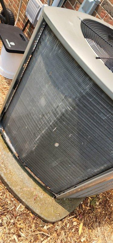 Completed preventive maintenance inspection on residential cooling system. Documented outdoor condensing unit condition, noting significant debris accumulation and discoloration on mesh filter screen requiring attention. Inspected indoor evaporator coil assembly, verifying coil fins remain intact and components properly secured with no visible deterioration or excessive buildup detected.