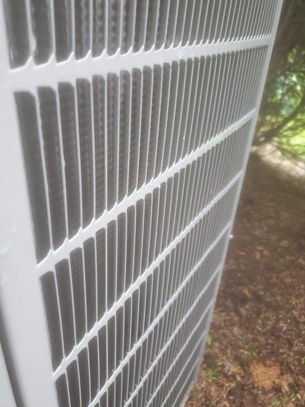 Completed comprehensive preventive maintenance on Bryant brand outdoor air conditioning condenser unit located at rear of property. Performed standard AC tune-up protocol including visual inspection of cabinet and coil fins, which were found to be clean and in excellent condition with no debris accumulation, damage, or corrosion noted. All exterior components including louvered ventilation panels and metal casing showed normal weathering with structural integrity intact and proper airflow capability maintained throughout unit.