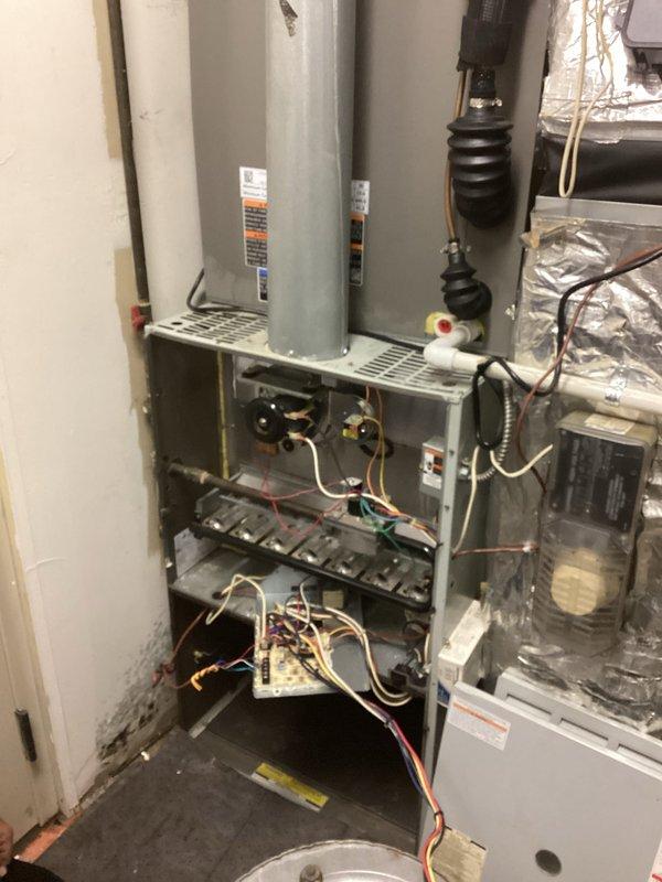 Conducted comprehensive evaluation of existing residential HVAC system for complete equipment replacement estimate. Assessed current gas furnace installation, water heater configuration, and associated ductwork within mechanical closet space. Documented existing equipment specifications, spatial constraints, and installation conditions including reflective insulation barriers and ventilation routing. Photographed furnace interior components, burner assembly, gas connections, electrical wiring, control boards, and overall system layout to develop accurate replacement specifications and scope of work for proposed new equipment installation.