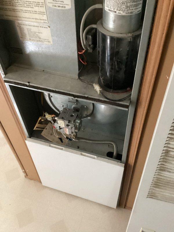 Provided comprehensive estimate for complete HVAC system replacement including both indoor furnace and outdoor air conditioning condenser unit. Existing 15-year-old system is non-operational and located in interior closet space with natural gas furnace configuration. Documented current equipment condition showing standard residential gas furnace with aging components and outdoor condenser unit with overgrown vegetation requiring clearance for proper airflow and accessibility during replacement installation.