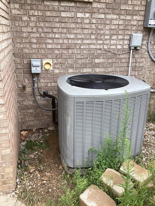 Completed estimate for residential air conditioning system replacement. Unit assessed as 16 years old and found to be low on R-410A refrigerant, indicating potential leak and end of serviceable life. Documented existing outdoor condensing unit and indoor mechanical equipment installation, photographed current system configuration including electrical disconnect and refrigerant line routing for replacement specifications.