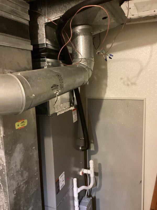 Conducted comprehensive estimate for complete HVAC system replacement on 14-year-old residential air conditioning unit experiencing refrigerant loss. System evaluation revealed low refrigerant levels (2-3 pounds deficient), indicating potential leak or age-related component failure. Documented existing outdoor condensing unit positioned on concrete pad with proper electrical disconnect and existing indoor air handler with associated ductwork and refrigerant line configuration. Photographed current installation including exterior unit placement, electrical connections, and complete indoor mechanical room setup showing existing ductwork, refrigerant lines, electrical panel access, and condensate drainage system to support replacement specifications and equipment sizing recommendations.