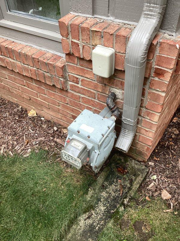 Conducted comprehensive electrical site assessment for backup generator installation at residential property. Evaluated existing electrical infrastructure including 240V air conditioning disconnect box and main service panel location. Documented current electrical service configuration, conduit pathways, and potential generator placement area adjacent to gas meter on exterior brick wall. Assessed clearance requirements, fuel source proximity, and optimal transfer switch location for seamless integration with existing electrical system.