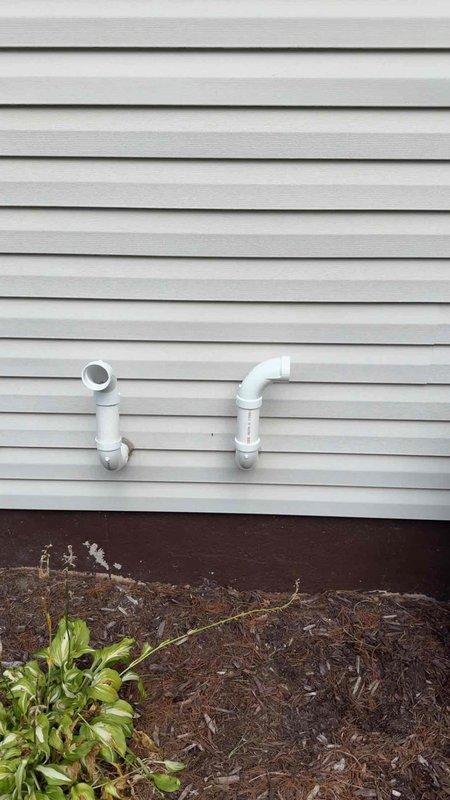 Installed combustion air supply system to mechanical room to meet required 3,300 cubic feet ventilation capacity per code requirements. Routed white PVC intake and exhaust piping through exterior wall with proper termination elbows, connecting to HVAC equipment in basement utility area alongside existing ductwork and plumbing infrastructure. Documentation photos captured for warranty compliance and follow-up verification.