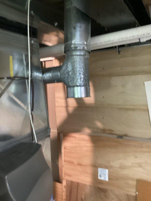 Responded to service call for residential water heater leaking from bottom of tank. Upon arrival, performed visual inspection of existing water heater installation in basement utility area. Confirmed active leak originating from base of unit, with visible water residue and mineral deposits on concrete floor surrounding tank base. Unit warranty had recently expired. Documented existing installation configuration including copper supply line connections, gas valve assembly, and condensate pump setup. Photographed current water heater condition, surrounding mechanical systems, and HVAC ductwork in overhead space for estimate preparation. Provided comprehensive assessment for water heater replacement options.