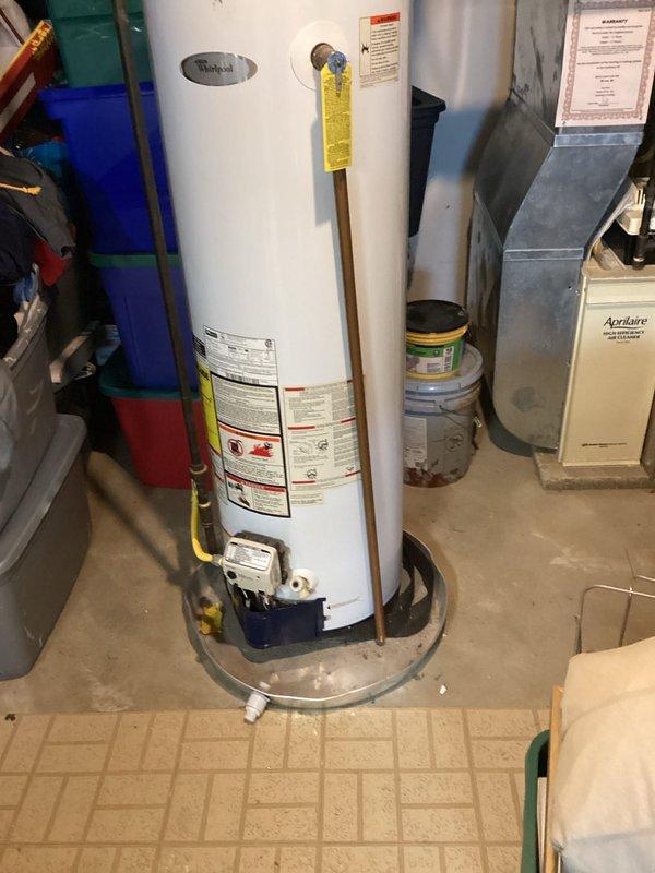 Provided estimate for replacement of existing Whirlpool hot water heater located in basement, unit over 10 years old and not functioning properly. Assessment included evaluation of current installation with gas line connection, venting system, and drip pan configuration for proper replacement specifications.