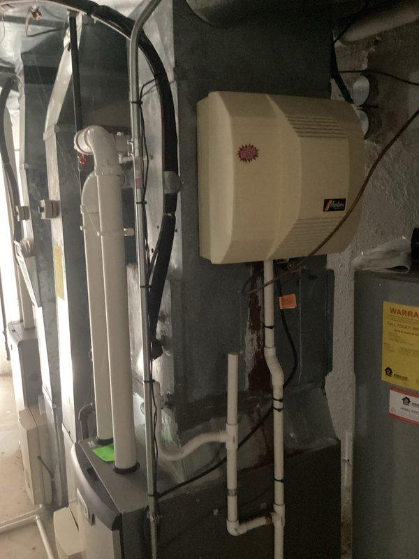 Completed comprehensive HVAC estimate for two-system air conditioning replacement, with primary focus on upstairs unit requiring complete installation. Documented existing basement mechanical equipment including Lennox furnace, humidifier, and associated ductwork and plumbing infrastructure to assess integration requirements for new AC systems.