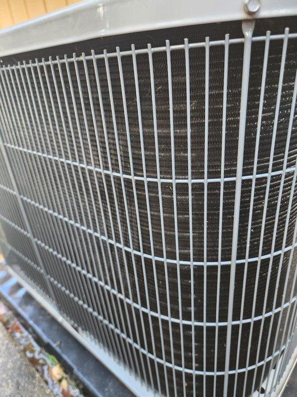 Completed routine cooling season maintenance on residential air conditioning system. Performed comprehensive inspection of outdoor condenser unit, verifying proper operation of compressor, checking refrigerant line connections, and examining condenser coil fins for cleanliness and damage. Condenser coils found in good condition with minimal debris accumulation. Indoor evaporator components inspected, including compressor housing and drain pan, which showed normal operational wear. All system components operating within manufacturer specifications with no immediate service needs identified.