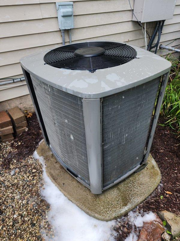 Completed annual maintenance on residential air conditioning system under WFS plan as non-covered visit. Performed comprehensive inspection of outdoor condensing unit including visual assessment of compressor, refrigerant lines, and electrical connections. Noted moderate aging and weathering on compressor with surface oxidation present on casing and drain pan showing rust staining from moisture exposure. Verified condenser coil condition and protective mesh panels intact. Confirmed unit operational status and proper mounting on concrete pad with electrical disconnect accessible.