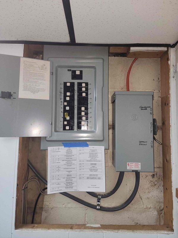 Completed residential electrical panel upgrade including installation of new 200-amp main breaker panel with dual rows of circuit breakers, generator interlock system with Detroit Edison-approved disconnect switch, and updated circuit directory documentation. Relocated and upgraded exterior electrical service equipment including new meter base installation, electrical conduit routing, and proper grounding connections to meet current code requirements.