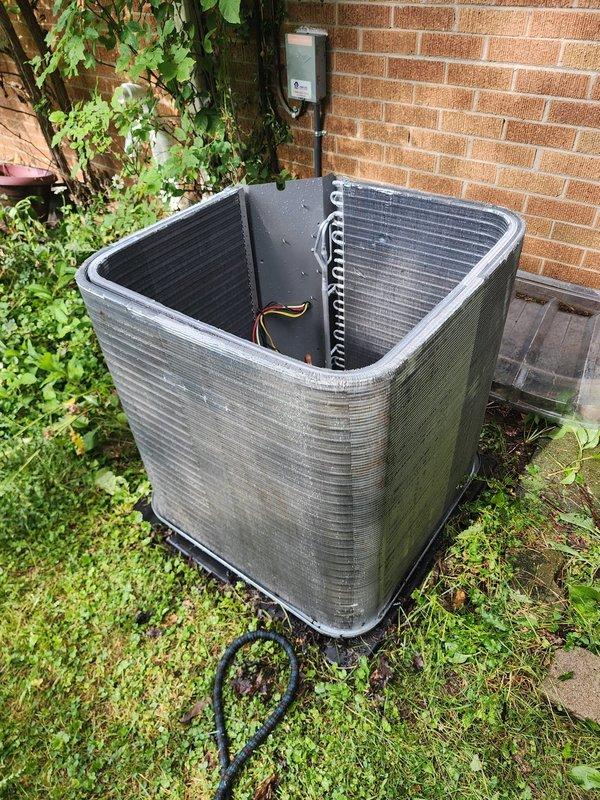 Completed comprehensive AC maintenance on outdoor condensing unit. Performed thorough inspection of condenser coils, capacitor, electrical connections, and fan motor assembly. Unit showed signs of outdoor weathering with algae growth on exterior panels and rust staining on mounting plate, which is typical for equipment exposed to elements. All electrical connections were inspected and found secure, with proper wire bundling observed. Condenser fins displayed normal dust and debris accumulation, which was addressed during service. System operational and running within normal parameters upon completion of maintenance visit.