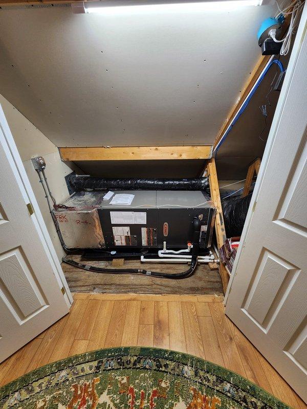 Completed full HVAC system installation including Lennox heat pump, gas furnace, air conditioning unit, and two S40 smart thermostats. Installed furnace in basement utility area with proper venting through white PVC intake and exhaust pipes, connected refrigerant lines with isolation valves, and integrated metallic supply ductwork. Mounted air handler unit horizontally in attic space across floor joists with black flexible ductwork connections and condensate drainage piping. Installed copper refrigerant line sets connecting outdoor heat pump unit to indoor components. Mounted and programmed both S40 thermostats for zone control. Verified all electrical connections at furnace control board and air handler, confirmed proper voltage and amperage readings. Tested system operation in heating and cooling modes, checked refrigerant pressures and superheat/subcooling values within manufacturer specifications. Confirmed adequate airflow across evaporator coil and heat exchanger. Verified conden
