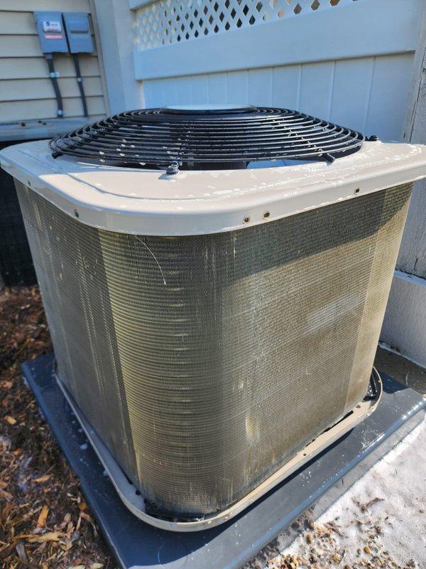 Completed scheduled AC maintenance on residential split system. Inspected outdoor condenser unit, noting accumulated debris on coil fins and surrounding base area. Examined indoor air handler components including evaporator coils, refrigerant lines, electrical connections, and condensate pan. Documented equipment condition with photos showing dust buildup on outdoor coil surfaces and moisture accumulation in drain pan area with visible sediment.
