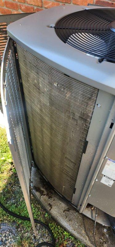 Completed scheduled maintenance tune-up on residential cooling system. Performed comprehensive inspection of outdoor condensing unit and air handler, documenting significant dirt and debris accumulation on condenser coil fins requiring attention. System confirmed operational at time of service with all components functioning properly.
