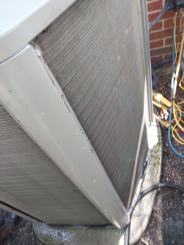 Responded to complaint of insufficient cooling and intermittent surging sounds from outdoor unit. Upon inspection, found outdoor condenser unit operational but exhibiting performance issues. Examined refrigerant lines, condenser coils, and electrical connections at outdoor unit. Inspected indoor air handler and discovered significant brown staining and mineral buildup in condensate drain pan, indicating prolonged moisture accumulation and potential drainage issues. Condensate pump showed signs of extended use with corrosion present in collection tray. Debris observed around outdoor unit base on concrete pad. System evaluated for airflow restrictions, refrigerant charge levels, and compressor operation. Addressed surging issue by checking electrical connections and capacitor function. Cleared drain line blockage and cleaned condensate collection system to restore proper drainage and prevent future overflow conditions that could impact system efficiency.