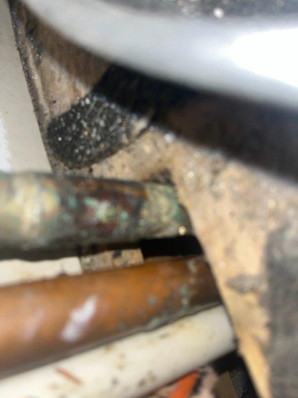 Successfully installed a new 30-gallon tanked water heater in residential utility space, replacing existing aged unit with heavily corroded copper piping. Completed all necessary plumbing connections using copper pipe and brass fittings, including installation of shut-off valves and pressure relief valve. Modified and rerouted furnace venting system to accommodate new water heater placement, installing flexible metallic duct work to ensure proper exhaust ventilation and code compliance. All connections tested and verified for proper operation and leak-free performance.