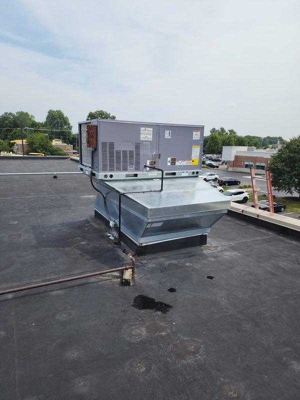 Completed installation of Bryant 5-ton, 110,000 BTU packaged rooftop unit on commercial building. Unit was crane-lifted into position at scheduled time and mounted on existing galvanized metal roof curb with proper sealing and weatherproofing. All electrical connections, refrigerant lines, and ductwork transitions were completed per manufacturer specifications, and system was tested for proper operation before final commissioning.