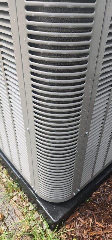 Completed comprehensive cooling season maintenance on residential outdoor air conditioning condenser unit per Worry Free Service Agreement protocol. Performed standard AC maintenance 3-5 checklist including visual inspection of unit exterior, verification of proper installation on base pad, assessment of cabinet condition and louver airflow clearances, and documentation of equipment status. Unit found operating within normal parameters with adequate clearances from surrounding vegetation and proper elevation on mounting pad.