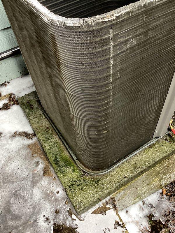 Performed routine air conditioning maintenance on outdoor condensing unit. Inspected compressor, refrigerant lines, and electrical connections inside unit compartment—all components found operating within normal parameters. Cleaned condenser coils to remove dirt and debris accumulation from exterior fins. Completed factory reset of thermostat per customer request to restore default settings.